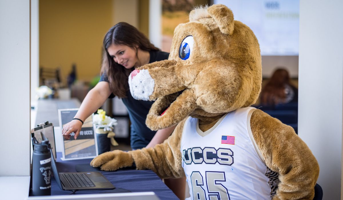 Clyde working with an Admissions Specialist on the computer