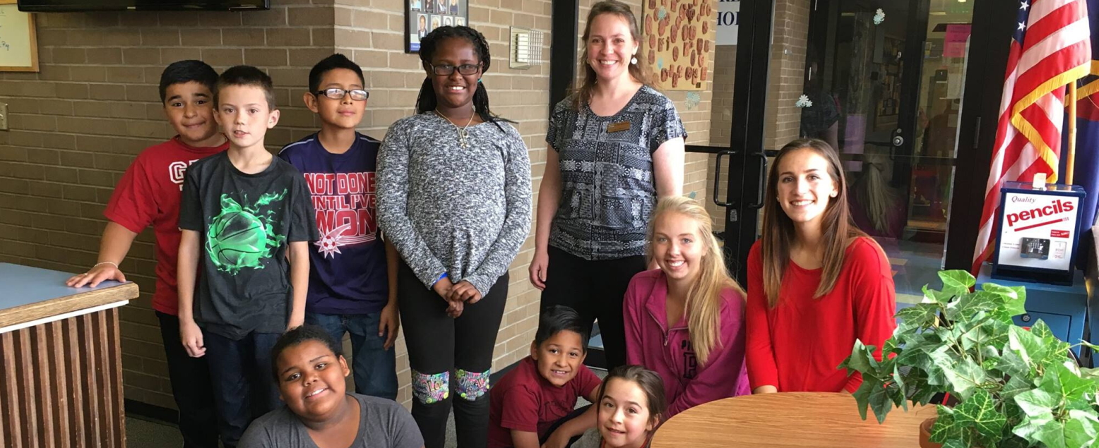 Teachers and interns with young students